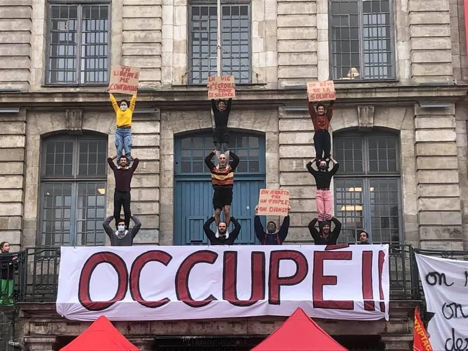 Circassian students from the Center Régional des Arts du Cirque sign their occupation of the Théâtre du Nord with acrobatics.